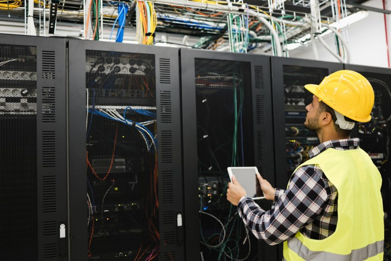 Technician performing regular maintenance on IT equipment